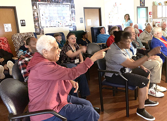 Group of senior citizens lauging and pointing.